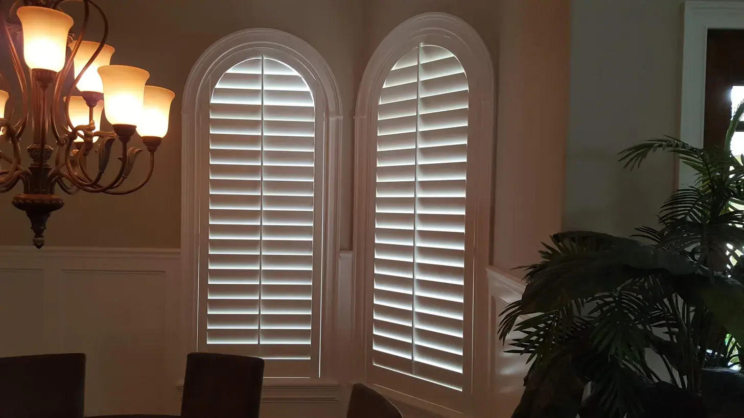 Full arch double window shutters in dining room