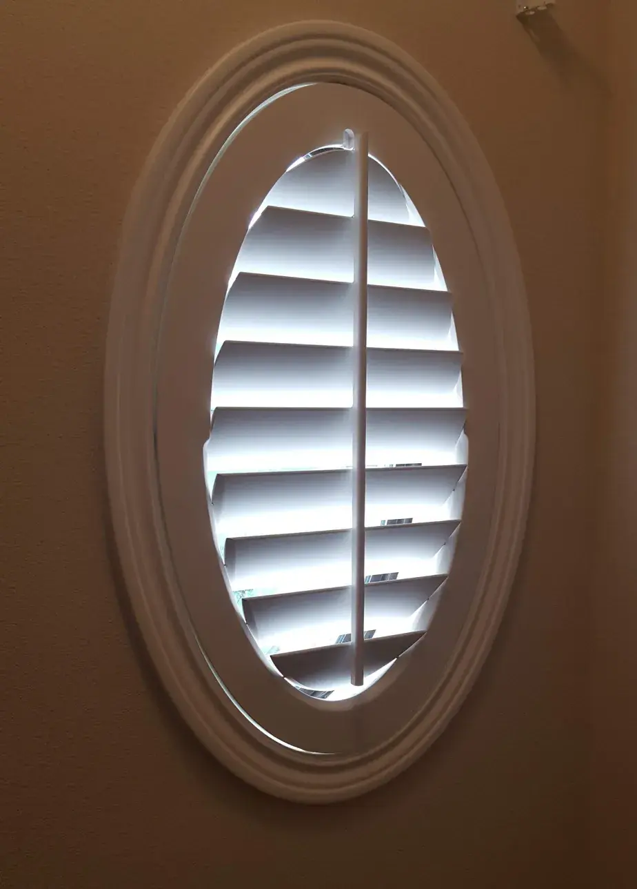Oval window plantation shutters