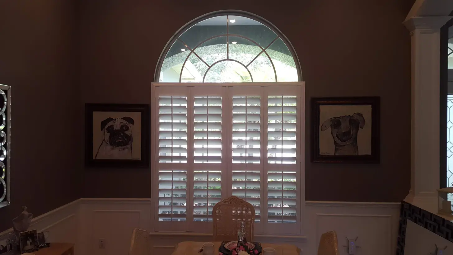 Fanlight arch with full height shutters below in dining room