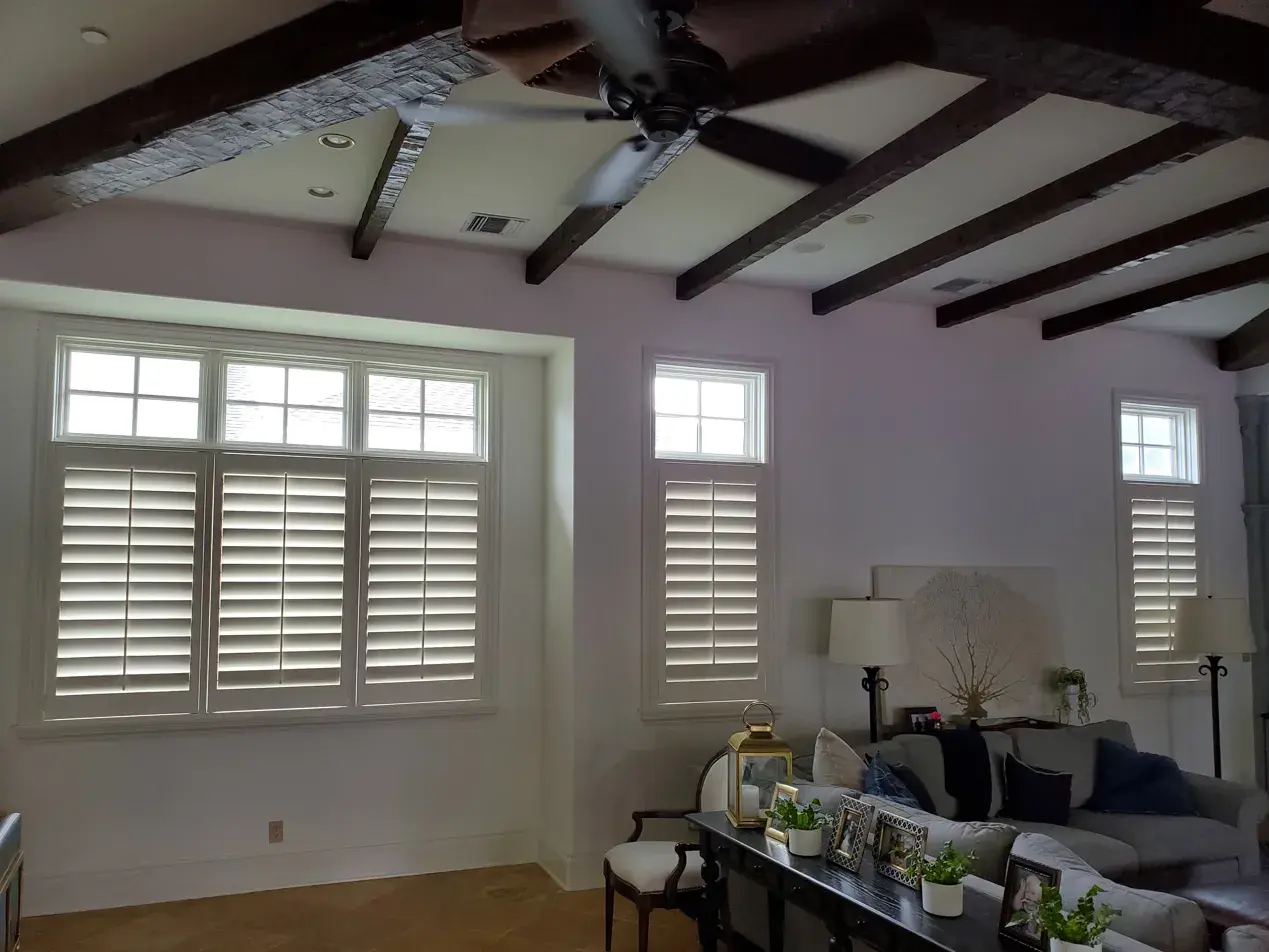 Café style shutters across multiple living room windows