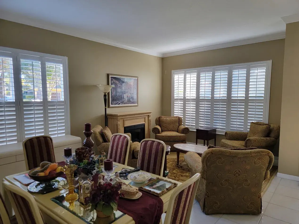 Full height shutters across multiple living room windows