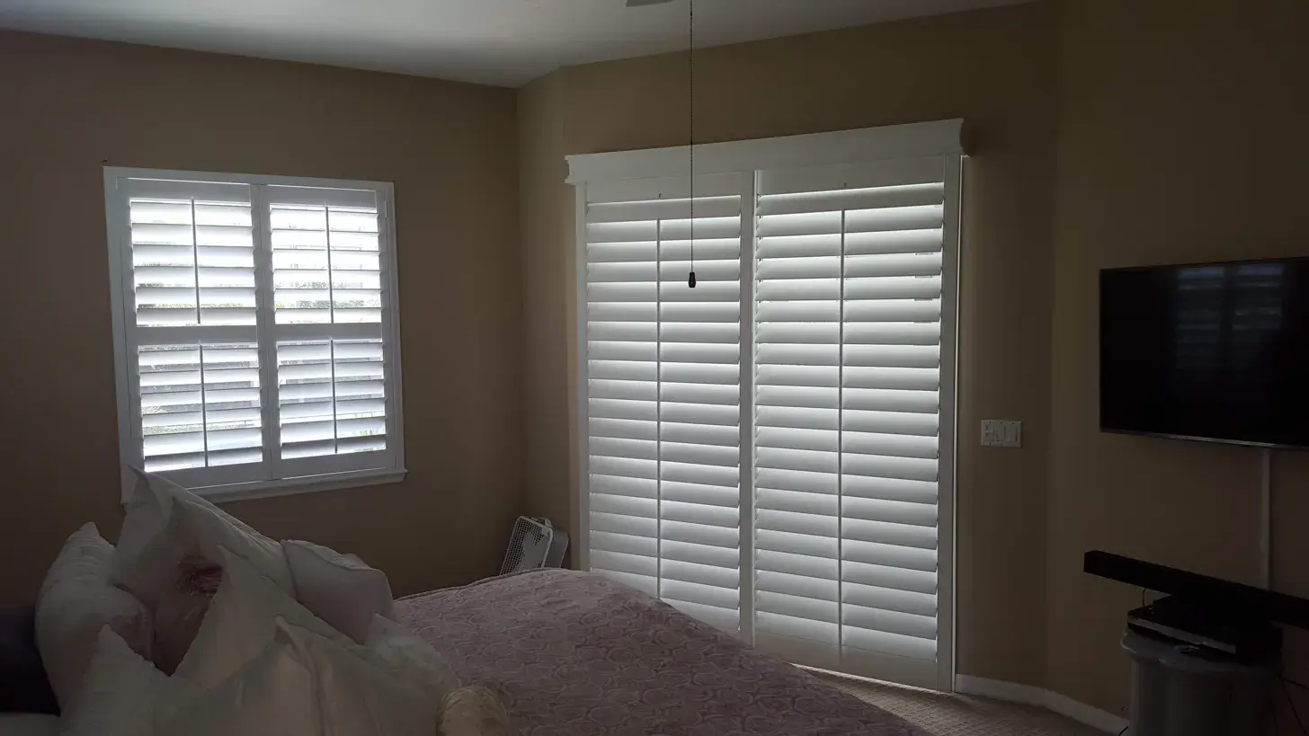 Full height shutters in bedroom corner