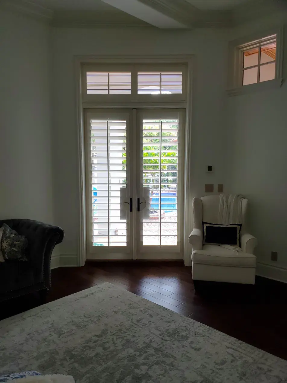 French door shutters in master bedroom with pool view
